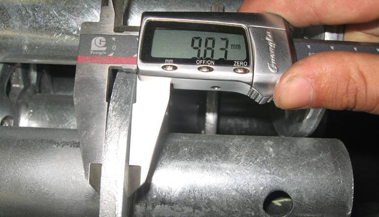 A caliper is used to check the ring thickness.