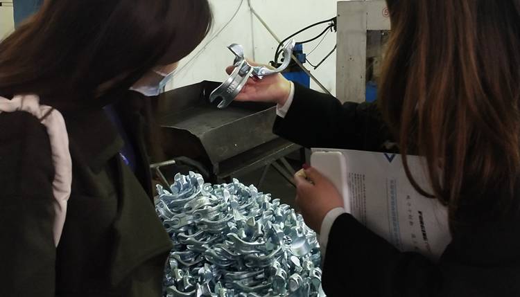 Our sales manager is introducing our scaffolding products to our customers in the coupler workshop.